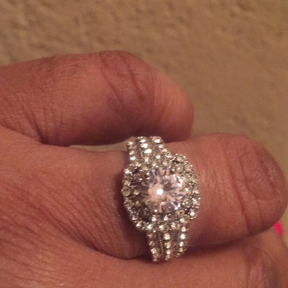 Sterling Silver round ring with clear stones .